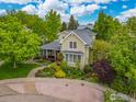 Aerial view of a charming home surrounded by lush trees with a landscaped front yard and inviting front porch at 1509 Poplar Ave, Boulder, CO 80304