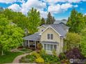 Aerial view of a beautifully landscaped home with mature trees and a well-manicured lawn at 1509 Poplar Ave, Boulder, CO 80304