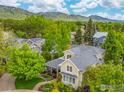 Panoramic aerial view showcasing neighborhood homes nestled amidst lush greenery and mountains at 1509 Poplar Ave, Boulder, CO 80304