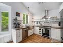 Bright kitchen featuring stainless steel appliances, white cabinetry and stylish countertops at 1820 Gordon Dr, Erie, CO 80516