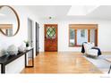 Bright foyer featuring hardwood floors, a stylish mirror, and a skylight at 1860 Hawthorn Ave, Boulder, CO 80304