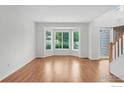 Inviting living room with bay window, hardwood floors, and neutral decor at 2047 Erie Ln, Superior, CO 80027