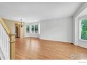 Bright living room featuring hardwood floors, natural light from large windows, and a cozy atmosphere at 2047 Erie Ln, Superior, CO 80027