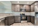 Modern kitchen featuring gray cabinets, stainless steel appliances, and granite countertops at 2435 Calais Dr # G, Longmont, CO 80504