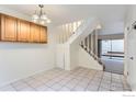 Sunlit dining room with tile floors, adjacent staircase, and sliding glass doors to patio at 3161 Madison Ave # 108, Boulder, CO 80303