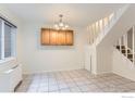 Open-concept dining room with white tile flooring, adjacent staircase, and natural light at 3161 Madison Ave # 108, Boulder, CO 80303