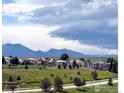 Picturesque community view featuring lush green spaces and mountain views in the background at 3223 Castle Peak Ave, Superior, CO 80027