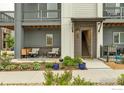 Inviting front porch features a seating area with plants, with direct access to unit #605 at 605 Promenade Dr, Superior, CO 80027