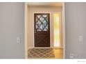 A welcoming entryway with a decorative front door, sidelight window, and stylish rug at 633 S Galena St, Denver, CO 80247