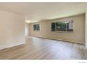 Bright and spacious living room with modern flooring and large windows for ample natural light at 633 S Galena St, Denver, CO 80247
