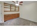 Bedroom with built in cabinets, shelves, and carpeted flooring at 6505 Kalua Rd # 104, Boulder, CO 80301