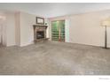 Spacious living room featuring a stone fireplace and sliding glass doors to a patio at 6505 Kalua Rd # 104, Boulder, CO 80301