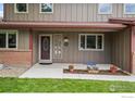 Inviting front entrance with decorative glass door, sidelights, and colorful flowers at 7409 Mount Meeker Rd, Longmont, CO 80503