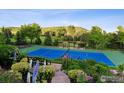 Beautifully landscaped tennis court area with pergola and scenic views at 8000 N 41St St, Longmont, CO 80503