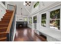 Bright living room with large windows, fireplace, and staircase at 1010 Euclid Ave, Boulder, CO 80302