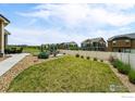 Expansive backyard featuring lush green grass, a cozy seating area, and a private fence, perfect for outdoor enjoyment at 1060 Arrowhead Ct, Erie, CO 80516