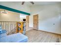 Comfortable living space featuring new hardwood floors, a modern railing and plenty of natural light at 10940 Utica Ct, Westminster, CO 80031