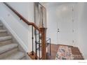 Bright foyer with hardwood floors, staircase, and a view of the front door at 1416 Monroe Ct, Longmont, CO 80501
