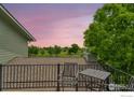 Cozy balcony setup with chairs and table, overlooking landscaped yard, with a peaceful, scenic view at 15545 Lipan St, Broomfield, CO 80023