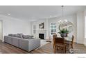 Bright living room with fireplace, large windows, and contemporary decor, creating a cozy atmosphere at 1631 Poplar Dr, Erie, CO 80516