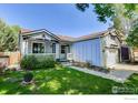 Charming single-Gathering home featuring a well-manicured front yard, inviting porch, and attached garage at 1673 Bain Dr, Erie, CO 80516