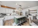 Bright kitchen featuring a large center island, modern appliances, and stylish finishes at 1892 Bell Dr, Erie, CO 80516