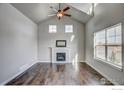Bright living room with vaulted ceiling, hardwood floors, fireplace and large windows at 210 High Point Dr, Longmont, CO 80504