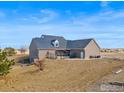 View of backyard with an outdoor seating area, offering a relaxing space for entertaining at 235 S County Road 23, Berthoud, CO 80513