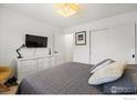 A cozy bedroom with a queen-size bed, dresser, and sliding closet doors at 2652 Sherwood Cir, Boulder, CO 80304