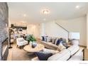 Comfortable living room with a decorative fireplace, plush seating, and an open floor plan at 2738 Bear Springs Cir, Longmont, CO 80503