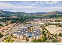 An elevated view of the condo community showcases the proximity to local businesses and restaurants, with mountain views beyond at 3301 Arapahoe Ave # 216, Boulder, CO 80303