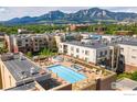 An aerial view captures the pool and hot tub area, showcasing the seating areas and mountain views of the building's amenities at 3301 Arapahoe Ave # 216, Boulder, CO 80303