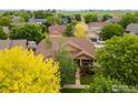 Charming home featuring a cozy front porch and beautifully landscaped front yard with mature trees at 336 Olympia Ave, Longmont, CO 80504