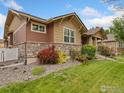 Attractive house with stone accents and vibrant landscaping at 336 Olympia Ave, Longmont, CO 80504