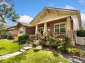 Inviting single-story home with stone accents and a lovely landscaped front yard at 336 Olympia Ave, Longmont, CO 80504