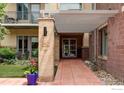 Inviting entrance to building with covered walkway, beautiful landscaping, and well-marked address at 3401 Arapahoe Ave # 310, Boulder, CO 80303