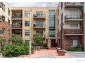 Modern condo building with multiple balconies, striking architecture, and manicured landscaping at 3401 Arapahoe Ave # 310, Boulder, CO 80303