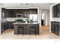 Modern kitchen with stainless steel appliances, dark cabinetry, and spacious island with seating at 3401 Arapahoe Ave # 310, Boulder, CO 80303