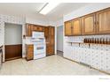 Well-lit kitchen equipped with wooden cabinets and white appliances at 40 Cornell Dr, Longmont, CO 80503