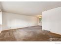 Spacious living room with plush carpet and lots of natural light at 40 Cornell Dr, Longmont, CO 80503