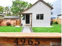 Front exterior of home with well-maintained lawn and charming facade at 4965 Clayton St, Denver, CO 80216