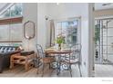Cozy dining area with a round table, stylish chairs, and natural light from the window at 6076 Gunbarrel Ave # F, Boulder, CO 80301