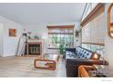 Comfortable living room featuring a brick fireplace, large window, and modern furnishings at 6076 Gunbarrel Ave # F, Boulder, CO 80301