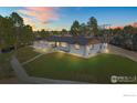 Beautifully renovated home with landscaped lawn, updated exterior, and driveway at sunset at 6766 Zenobia Loop, Westminster, CO 80030