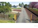 Sprawling property with a long driveway leading to the main house and mature trees at 6766 Zenobia Loop, Westminster, CO 80030