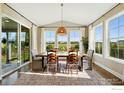 Bright dining room with large windows offers great views of the green lawn and surrounding community at 952 Pinecliff Dr, Erie, CO 80516