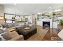 Inviting living room features a fireplace, built-in shelves, and opens to the kitchen for seamless entertaining at 952 Pinecliff Dr, Erie, CO 80516