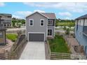 Features a two-car garage, nice backyard, and is located near a pond at 10604 Reunion Pkwy, Commerce City, CO 80022