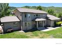 Charming two-story home with a well-manicured lawn and beautiful landscaping at 10886 Pheasant Run, Littleton, CO 80125