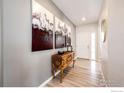 Welcoming entryway featuring stylish decor and a wood console table beneath large art pieces at 1191 Horsetail Loop, Elizabeth, CO 80107